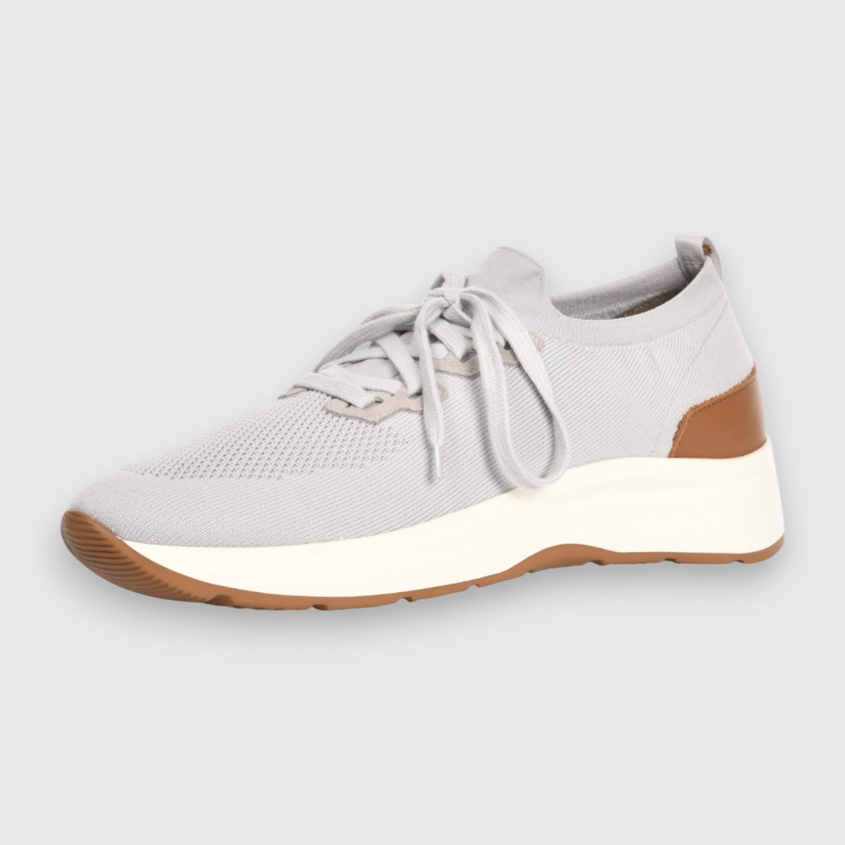 The Gran Sasso Light Grey Knitted Sneakers feature a modern, minimal design with a thick white sole, brown heel accent, and brown outsole detailing at the toe and heel, finished with light grey laces. , available at Richard Gelding Mayfair