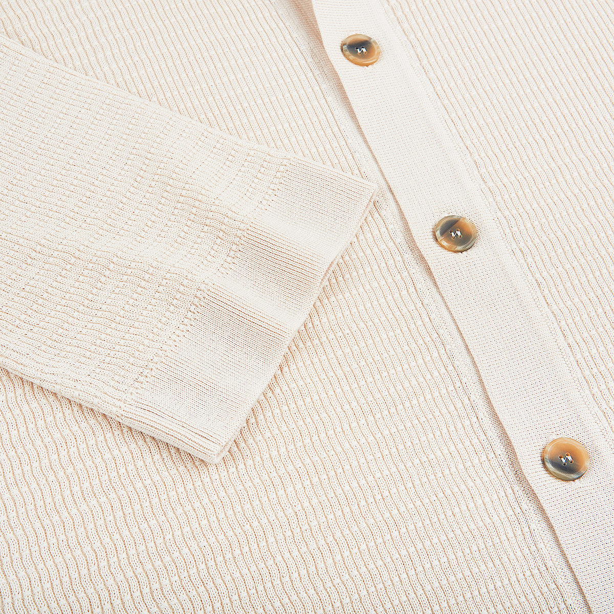 Close-up of the Altea Cream Blue Trim Waffle Cotton Button Polo, showing a sleeve and front with three glossy brown buttons. The cotton fabric features visible horizontal and vertical ribbing for a soft textured look. , available at Richard Gelding Mayfair