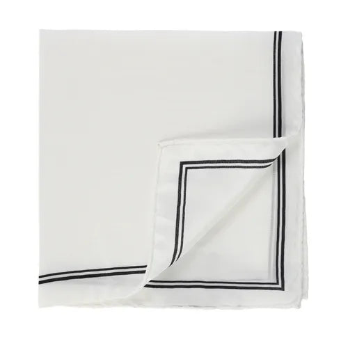 A Solid silk pocket square by Amanda Christensen, featuring a neatly folded white design with a thin black contrast double-line border near the edges. One corner is flipped to reveal the smooth, lightweight underside of the fabric. , available at Richard Gelding Mayfair