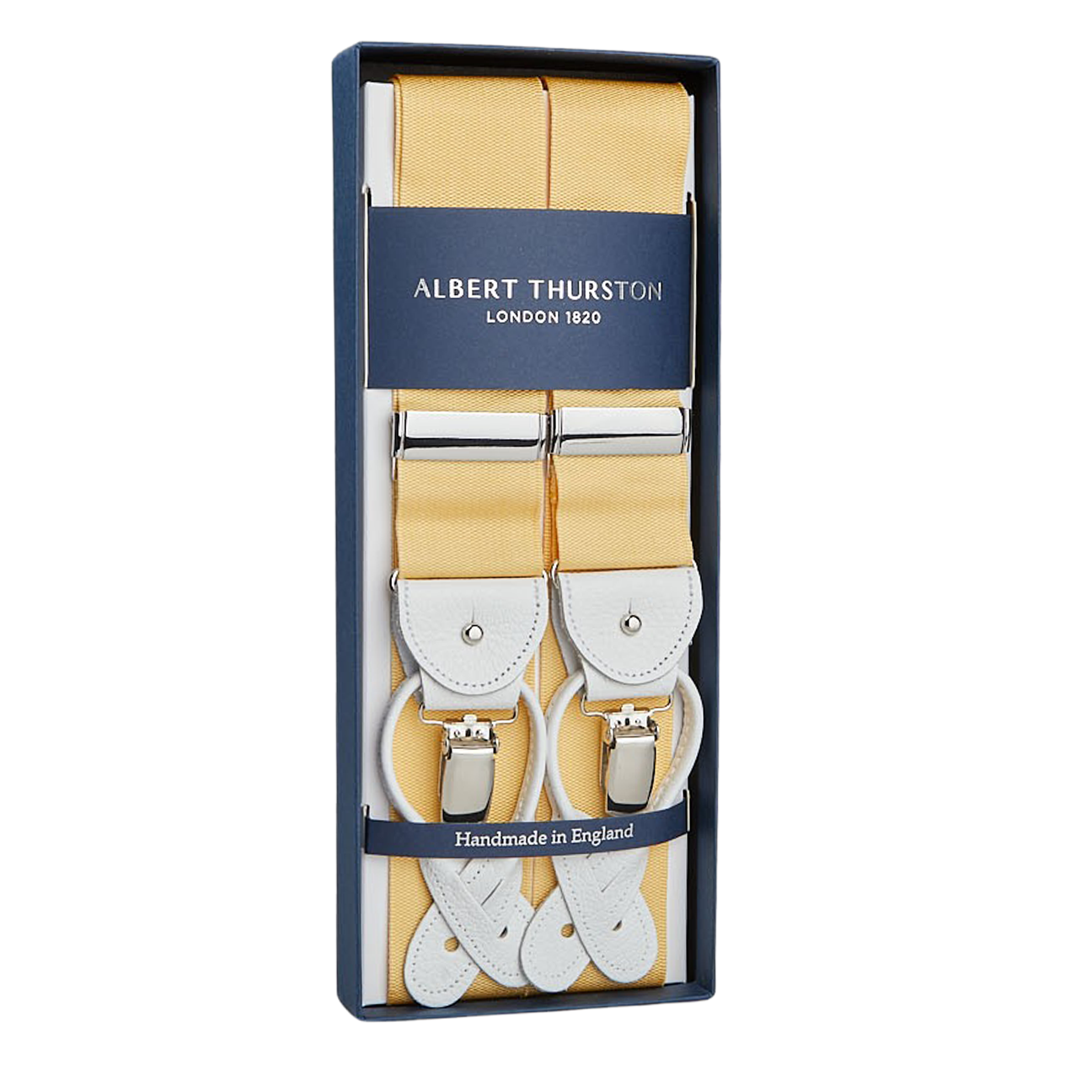 The package contains "Champagne Nylon Leather 40mm Braces" with white leather details and silver clasps by Albert Thurston, labeled "Albert Thurston London 1820," a renowned British brand famous for exquisite handmade braces, marked "Handmade in England.