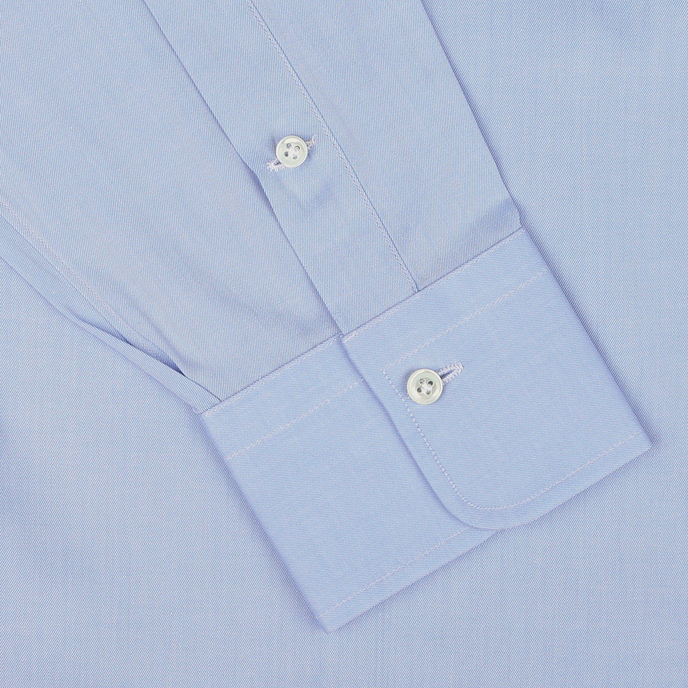 Close-up of an Alessandro Gherardi Sky Blue Cotton Twill Single Cuff Shirt sleeve, showcasing two white buttons on the pure cotton cuff.