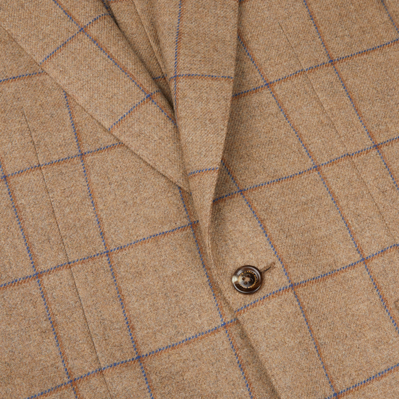 A close up of a Caramel Estate Wool Tweed Provence jacket with blue buttons, designed by Alexander Kraft Monte Carlo.