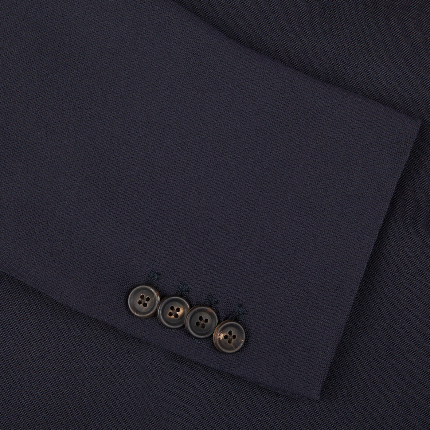 A close up of an Alexander Kraft Monte Carlo navy blue textured worsted wool signature jacket with buttons.