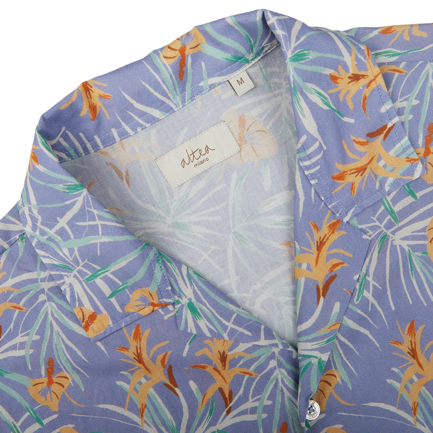 Close-up of a Light Blue Floral Printed Cotton Altea shirt with a visible brand label at the collar, a summer essential.