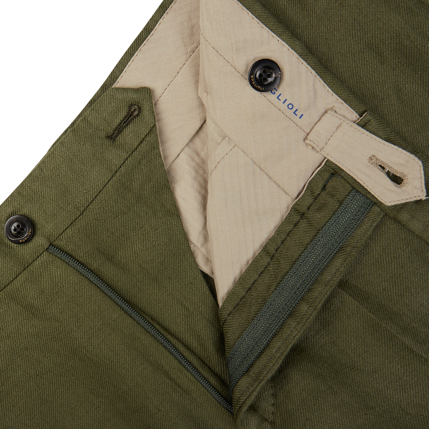 Close-up of an open olive green pair of Boglioli Green Washed Irish Linen Trousers with a zipper and a button, displaying the inner label and waistband construction.