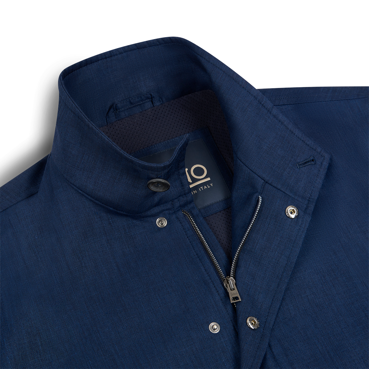 A close-up of a Herno Navy Wool/Silk/Linen Loro Piana Storm System Car Coat with a standing collar, silver snap buttons, and partially open zipper. The inner label shows size 10 and Made in Italy. The fabric is smooth with subtle sheen and slight texture. , available at Richard Gelding Mayfair