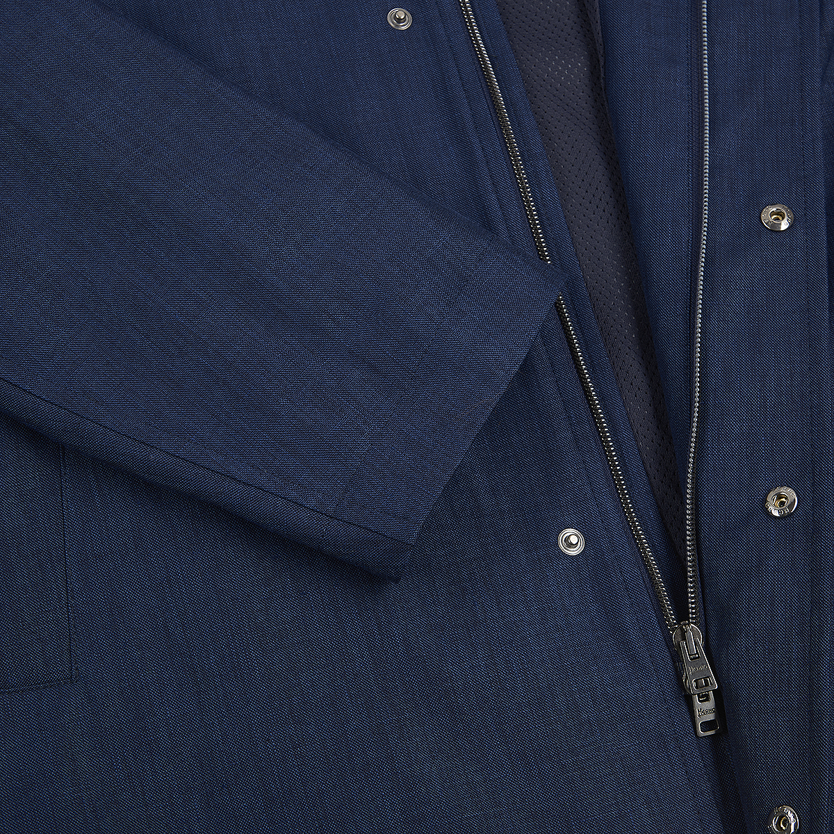 Close-up of a Herno Navy Wool/Silk/Linen Loro Piana Storm System Car Coat, showcasing the sleeve, visible stitching, partially open front zipper with snap buttons, and mesh-textured inner lining beneath the zipper. , available at Richard Gelding Mayfair