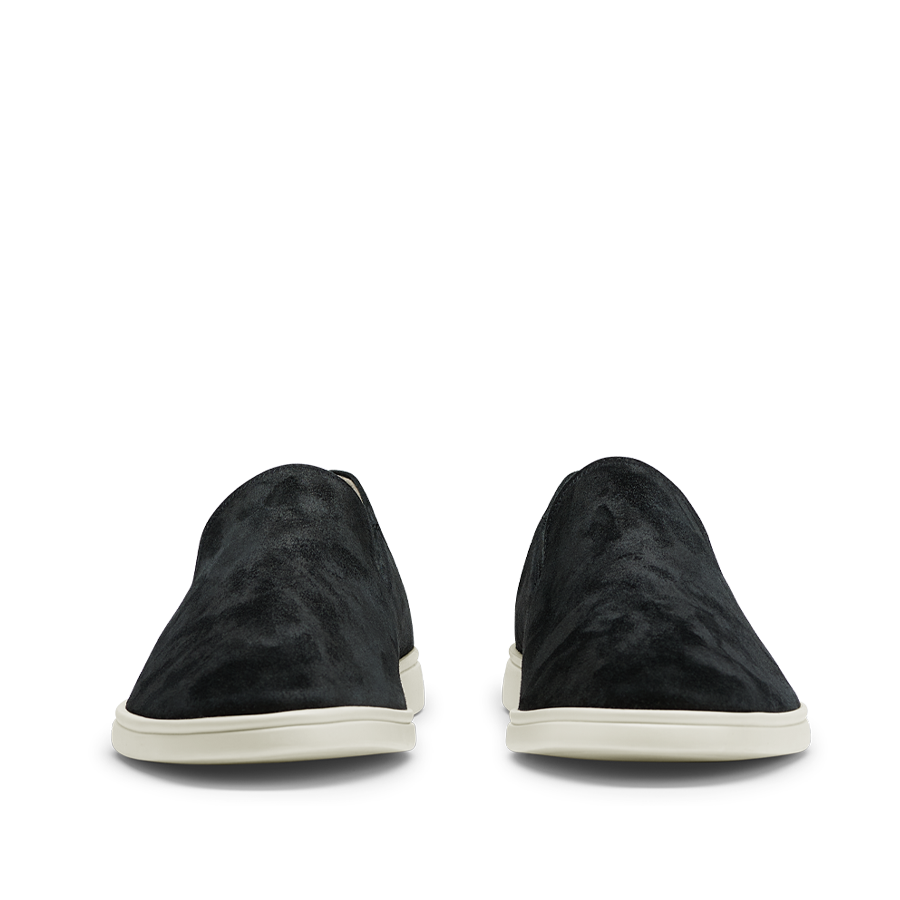 A pair of Black Suede Leather Vice Loafers by CQP with white soles positioned side by side on a striped background.