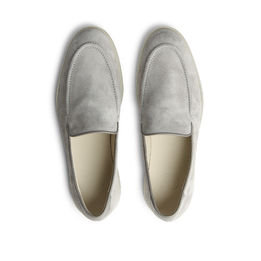 A pair of comfortable Cement Grey Suede Leather Debonair Loafers by CQP displayed against a black background.