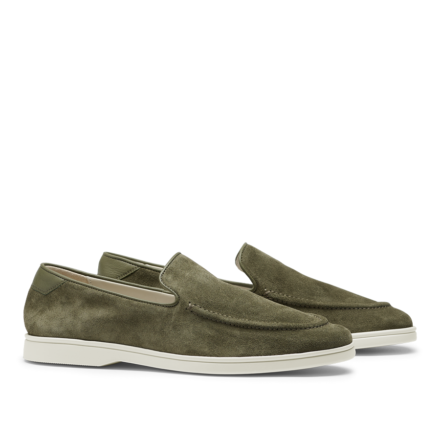 These CQP men's Juniper Green Suede Leather Debonair Slippers feature white rubber soles. Designed by a Swedish designer, they offer a sleek and modern look.