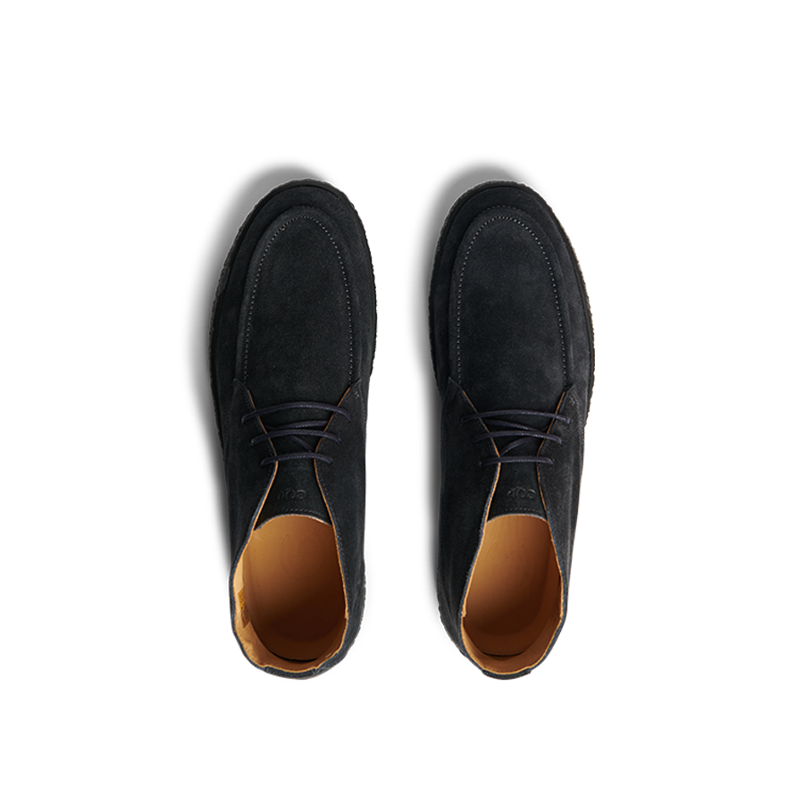 Top-down view of a pair of navy blue suede leather Plana boots by CQP, featuring tan interior linings and crepe soles.