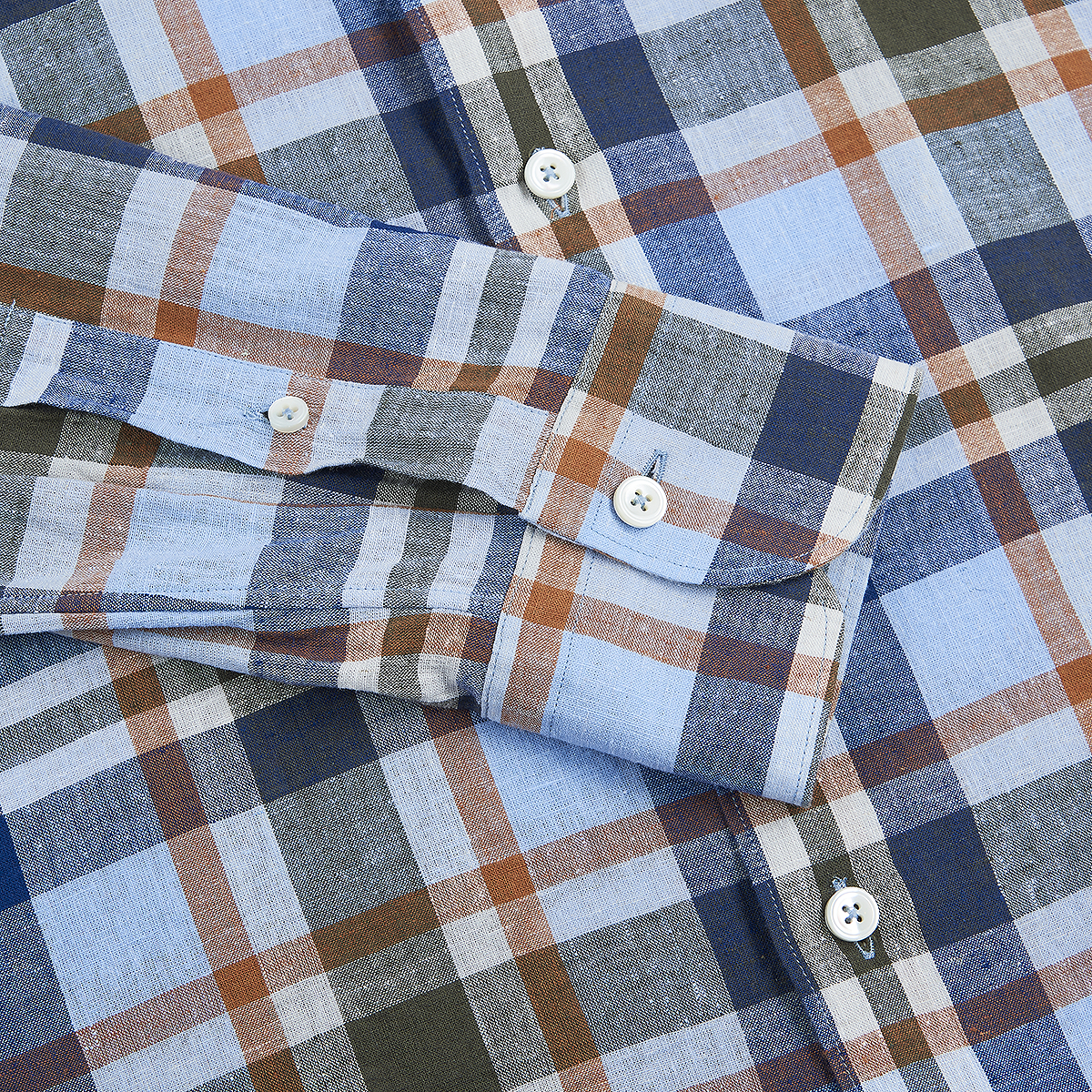 A close-up of the Alessandro Gherardi Blue/Orange Checked Linen Spread Collar Casual Shirt, neatly laid flat with sleeves folded over the chest, displaying white buttons on the cuff and placket. , available at Richard Gelding Mayfair