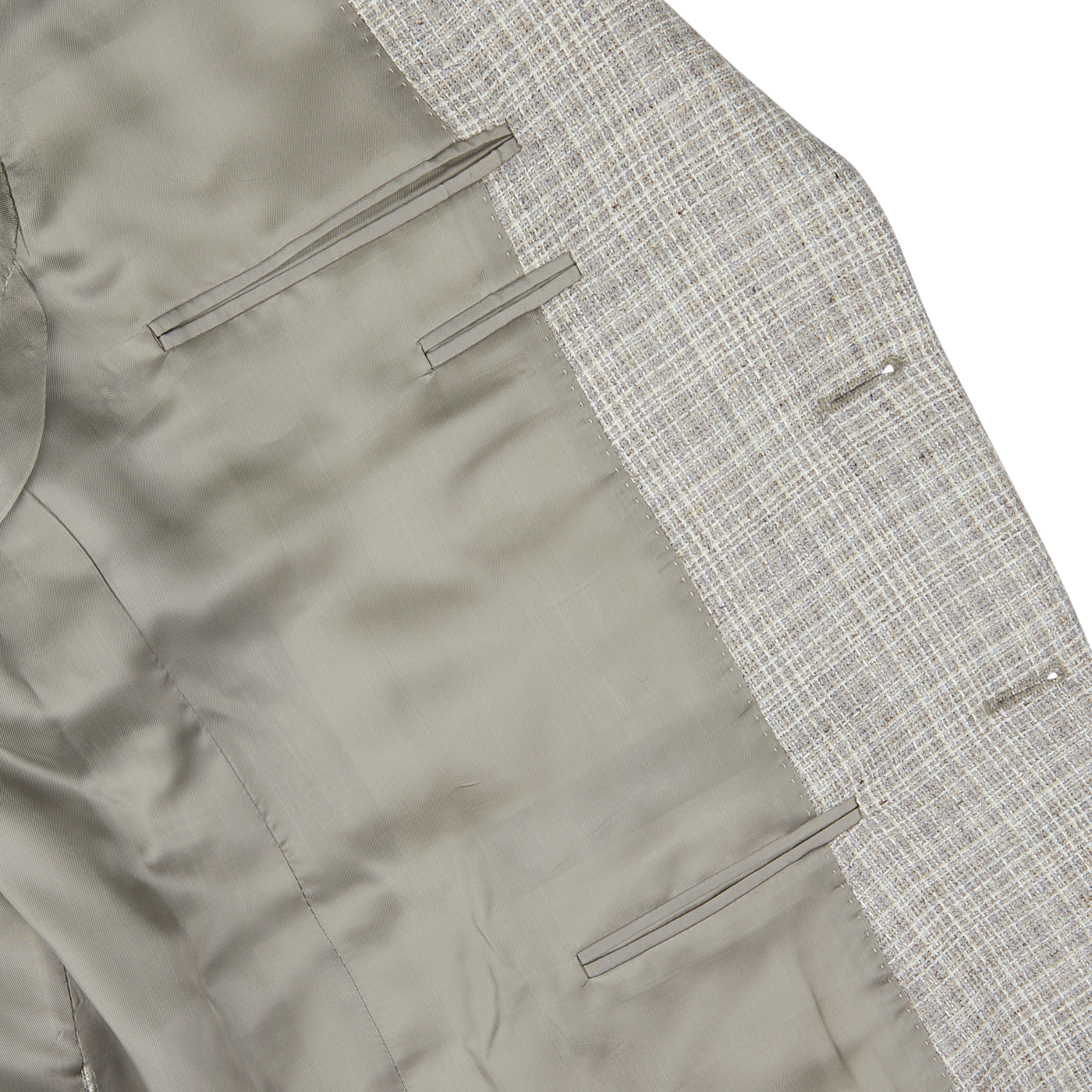 Close-up of a grey Canali beige melange silk wool basketweave blazer with tweed lapels and tailored pockets on a white background.
