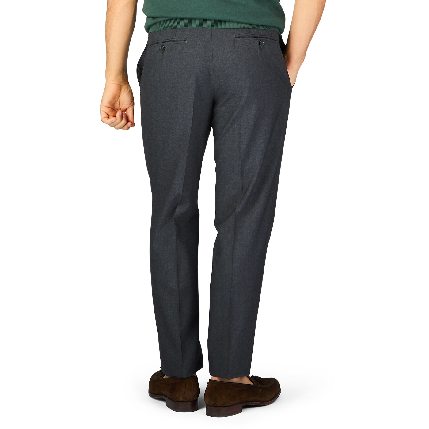 A person standing with their back toward the camera, wearing tailored formal Canali trousers in dark grey tropical wool and brown shoes.