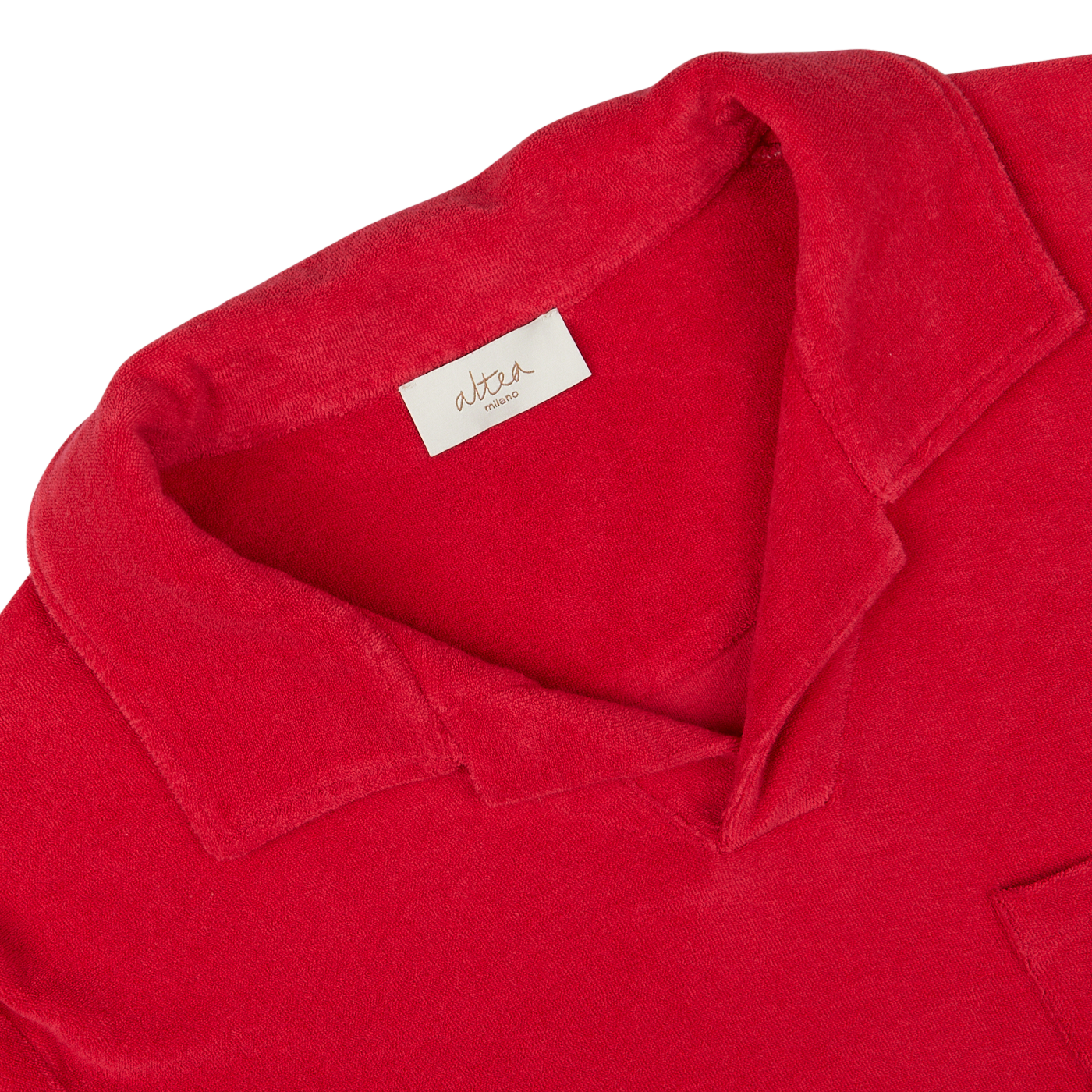 Close-up of an Altea coral red cotton towelling capri collar polo shirt label and collar.