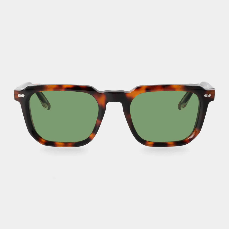 Front view of TBD Eyewear’s Dart Brown Havana | Green sunglasses, featuring bold tortoiseshell recyclable acetate frames with silver hinge accents and green mineral glass lenses, set against a plain white background. , available at Richard Gelding Mayfair