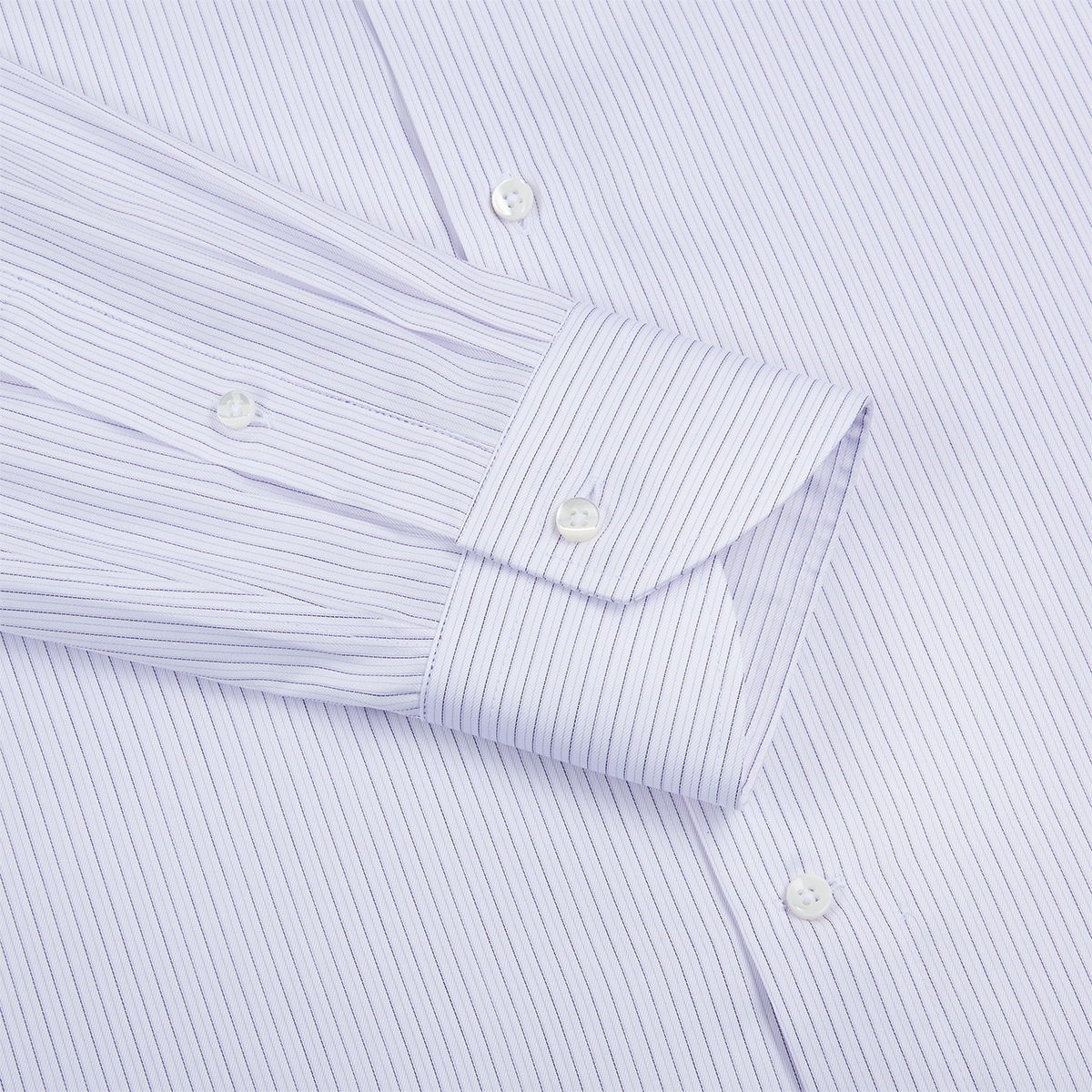 A close-up of the Canali Pink/Blue Stripe Cotton Shirt sleeve shows the cuff fastened with a white button; the neatly pressed shirt features fine vertical stripes and two extra white buttons on the body. , available at Richard Gelding Mayfair