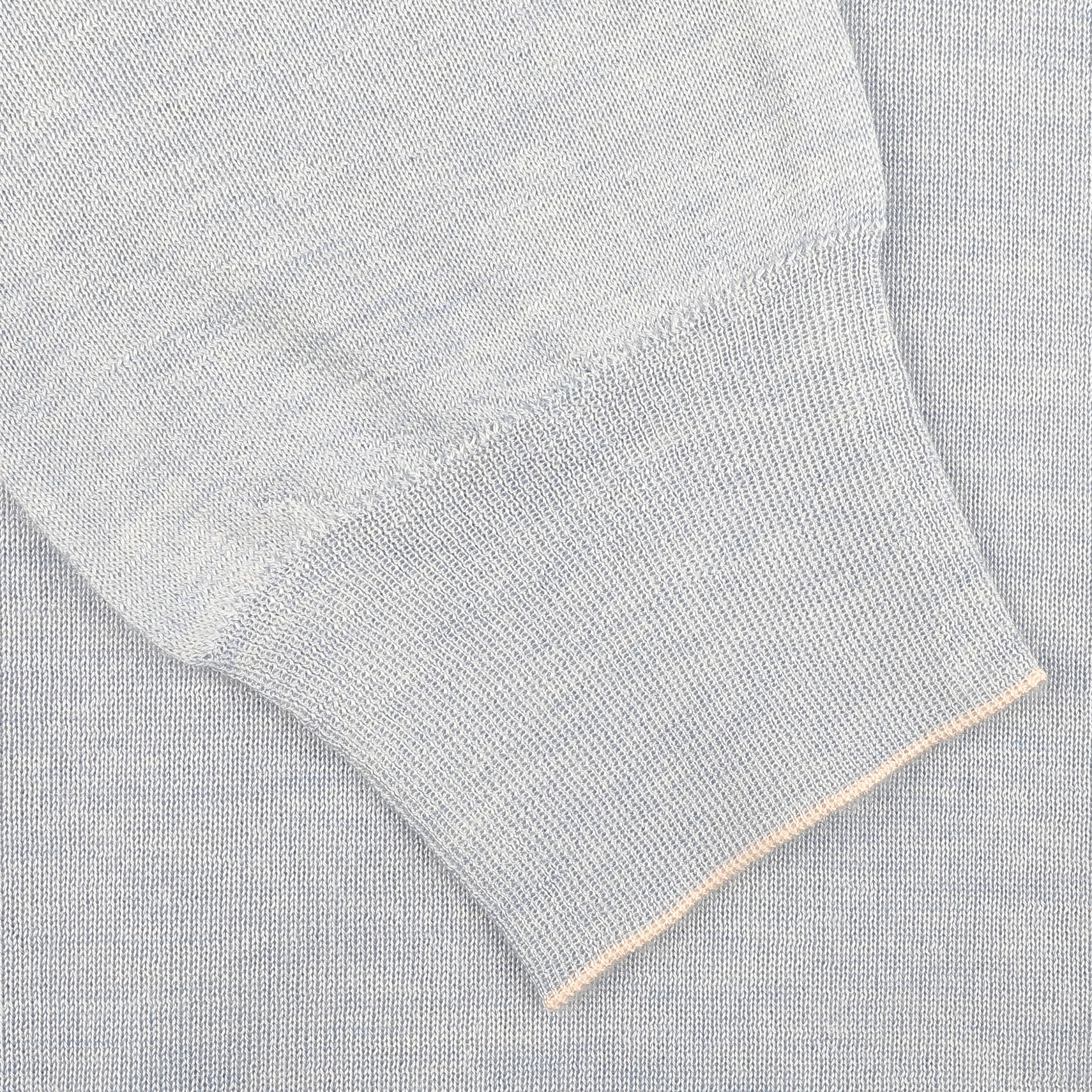 Close-up of a sky blue knit sleeve with ribbed cuff on the Fedeli Sky Blue Cashmere Silk 1/4 Zip Sweater, crafted from an exquisite cashmere-silk blend.