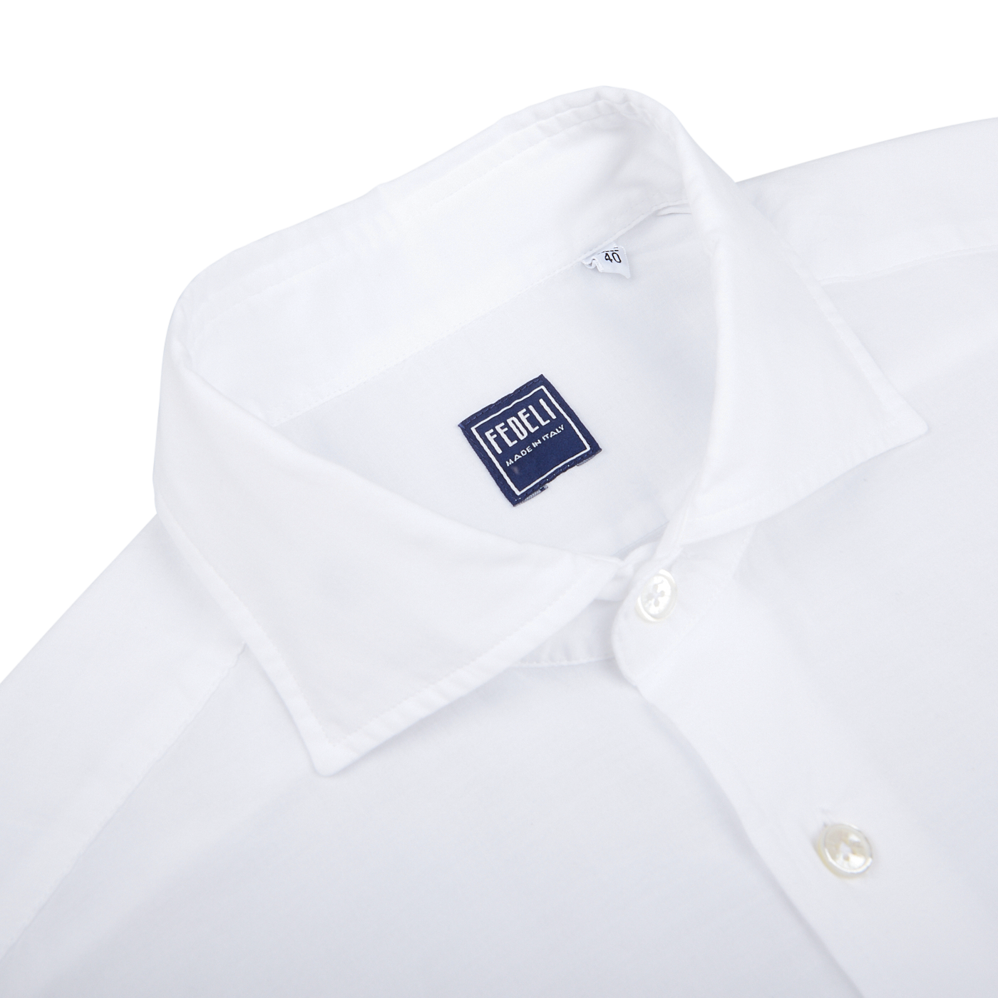 Close-up of a Fedeli white cotton stretch beach shirt with a label showing the brand name.