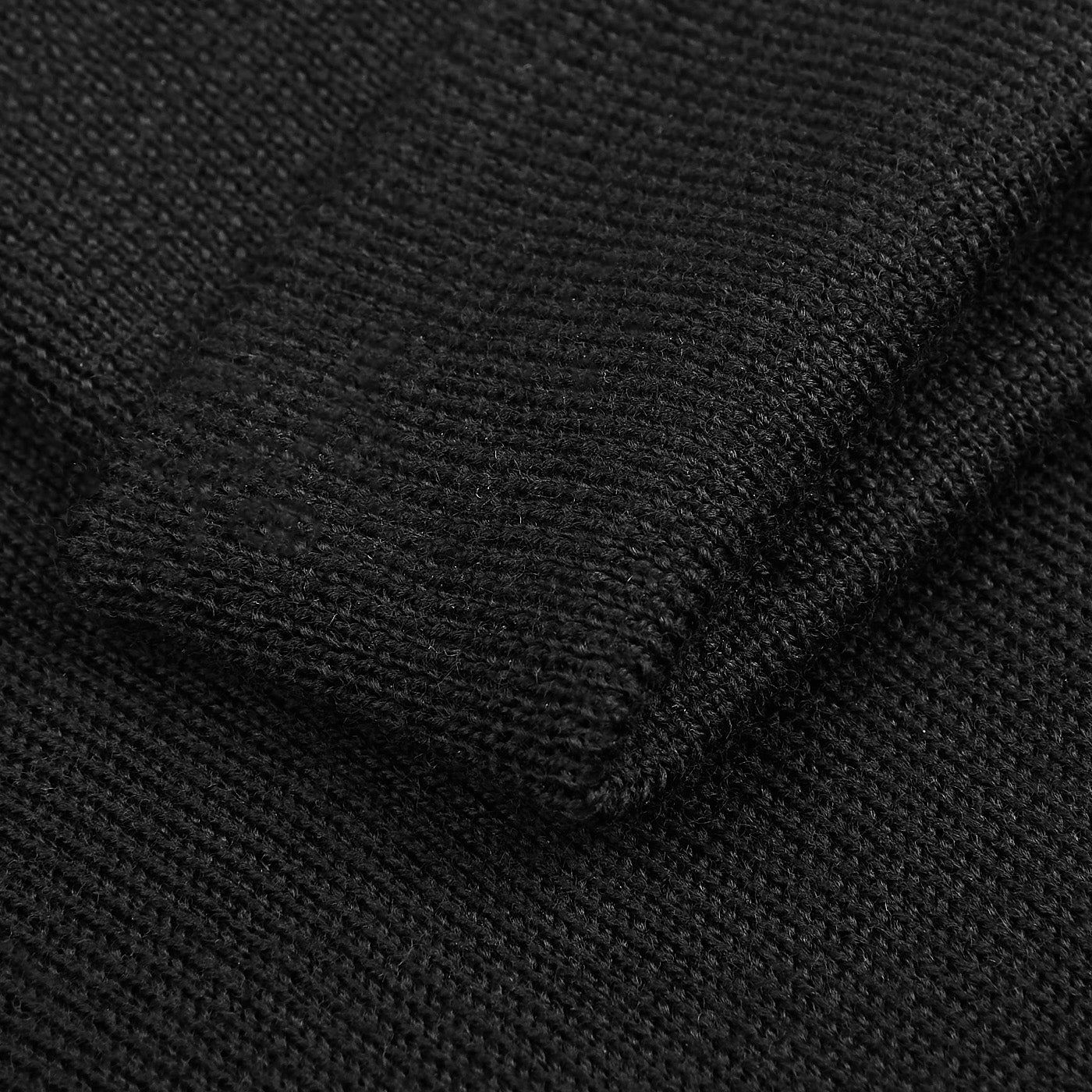 Close-up of the Gran Sasso Black Extra Fine Merino Wool Rollneck, highlighting the detailed knit texture and neatly finished edge—perfect for a refined, slim fit look.