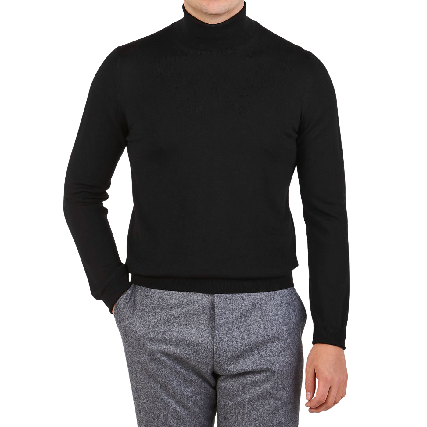 A person wears the Gran Sasso Black Extra Fine Merino Wool Rollneck with gray trousers, standing with one hand in their pocket against a plain background.
