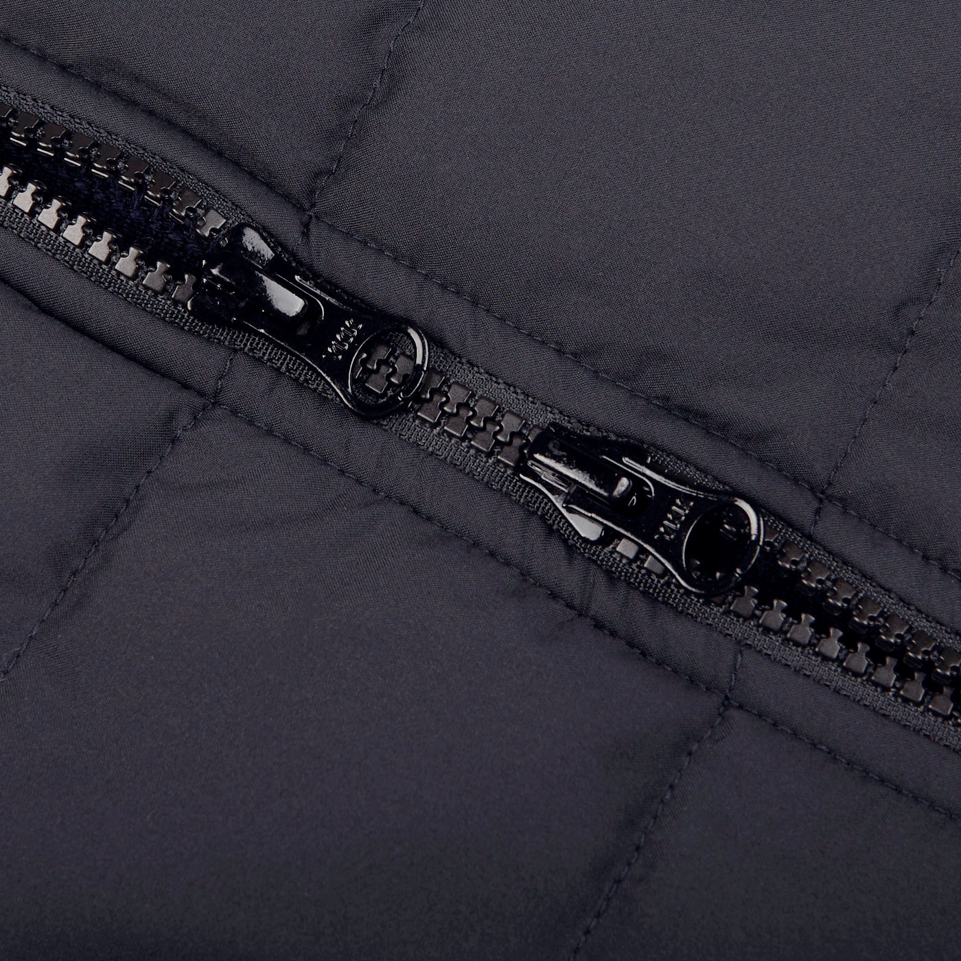 A close up of a water-resistant zipper on a Gran Sasso Navy Blue Rain Wool Knitted Jacket.