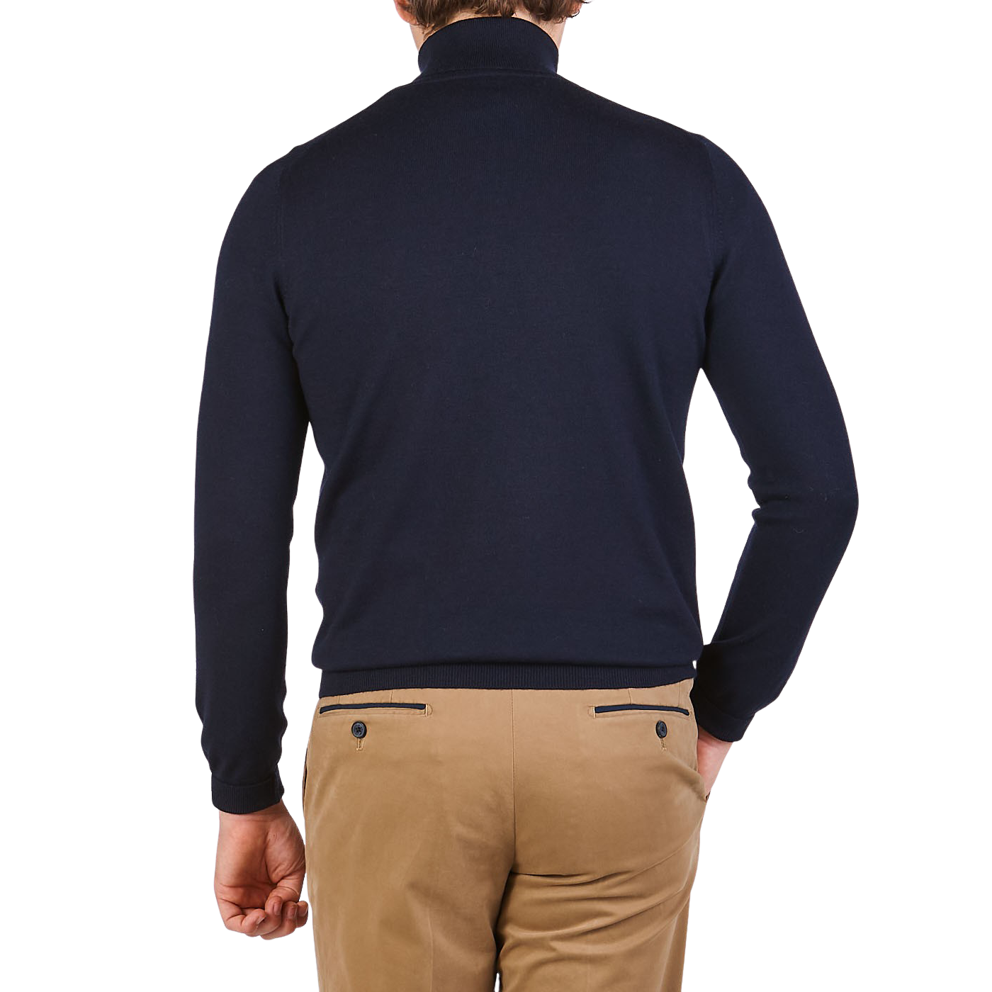 A person wearing a Gran Sasso Navy Blue Extra Fine Merino Wool Rollneck and beige pants stands with their back to the camera against a plain background.