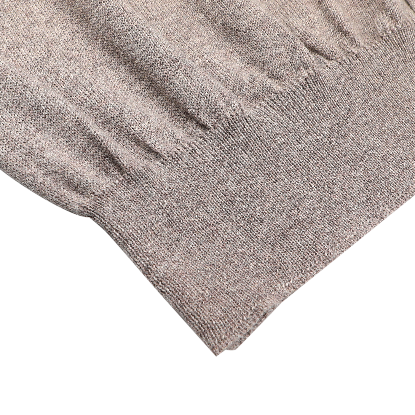 Close-up of the hem and lower sleeve of the Gran Sasso Beige Extra Fine Merino Wool Vest on a white background, ideal for layering with your favorite sleeveless cardigan.