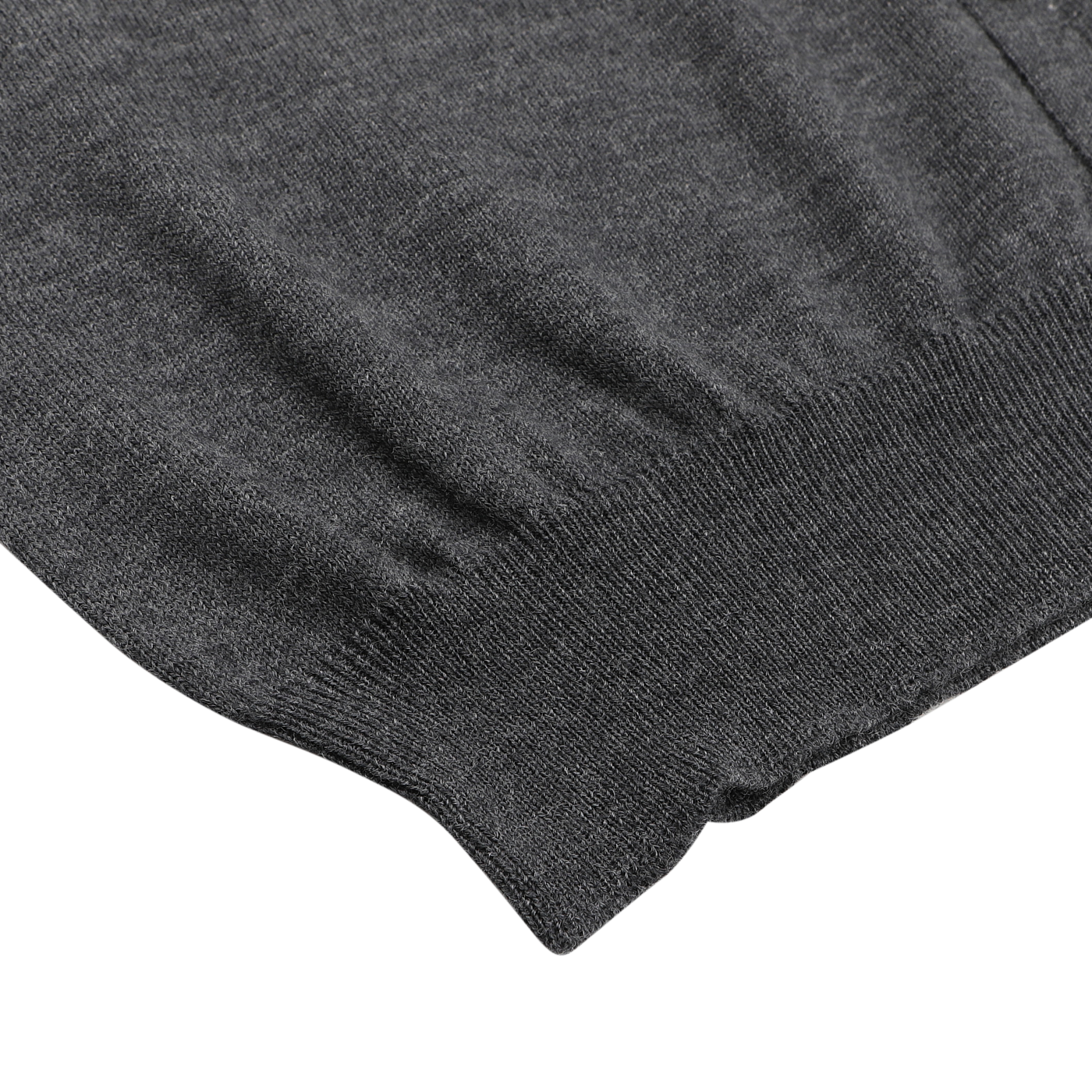 Close-up of the hem and lower part of the Gran Sasso Charcoal Extra Fine Merino Wool Vest, laid flat on a white background.