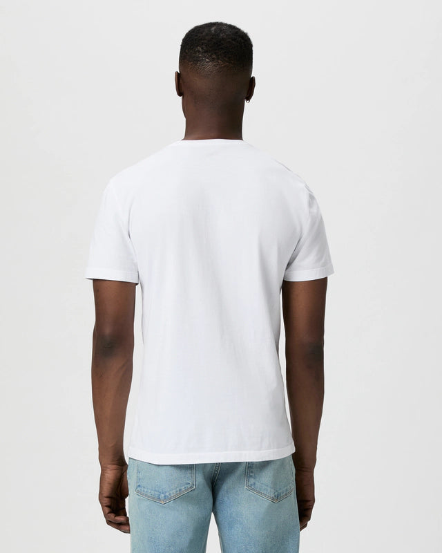 A man with closely cropped hair stands with his back to the camera, showing only his upper body. He wears a Paige White Cotton Sorden Crew Neck T-Shirt and light blue jeans against a plain white background, arms resting at his sides. , available at Richard Gelding Mayfair