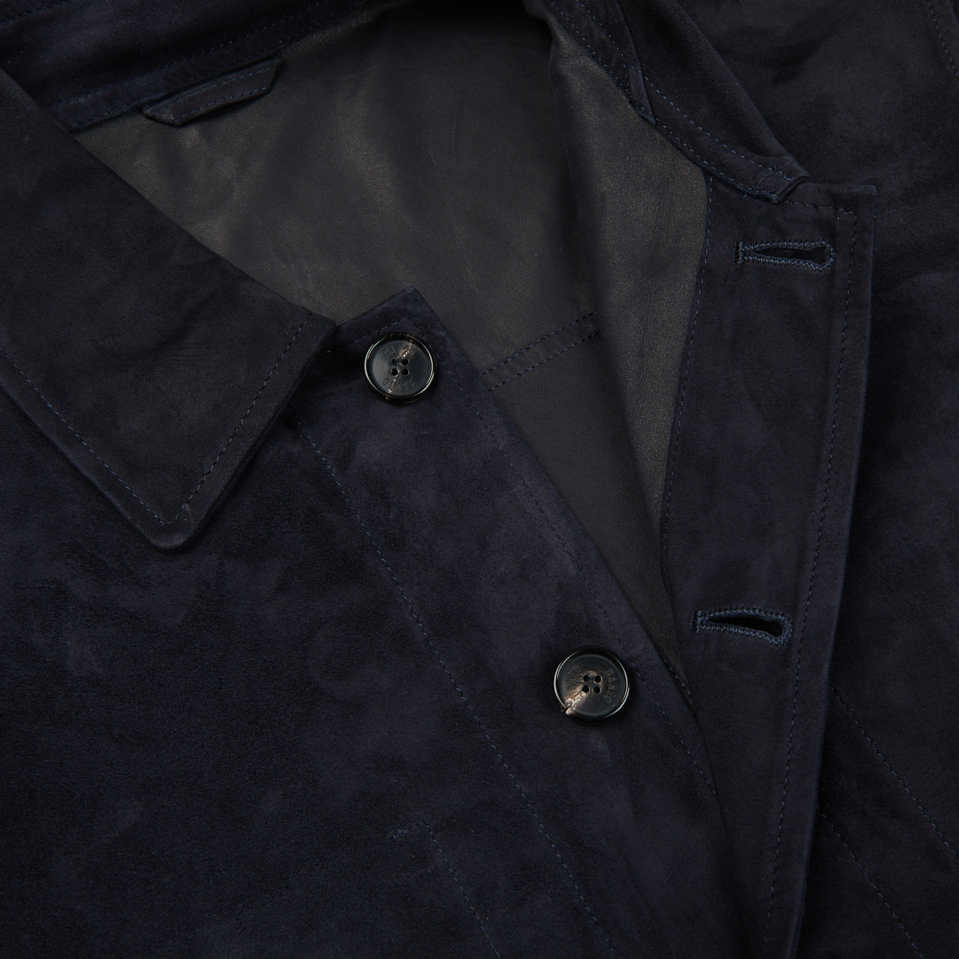 A close up image of a Manto navy blue suede leather overshirt.