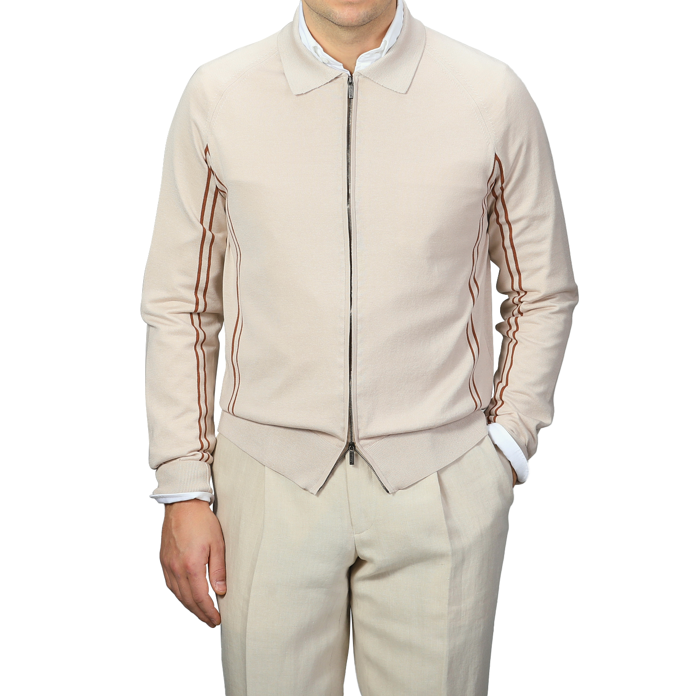 Dressed in a Maurizio Baldassari Beige Silk Cotton Full Zip Tennis Polo Shirt and beige pants, the person exudes Italian knitwear elegance against a gray background.