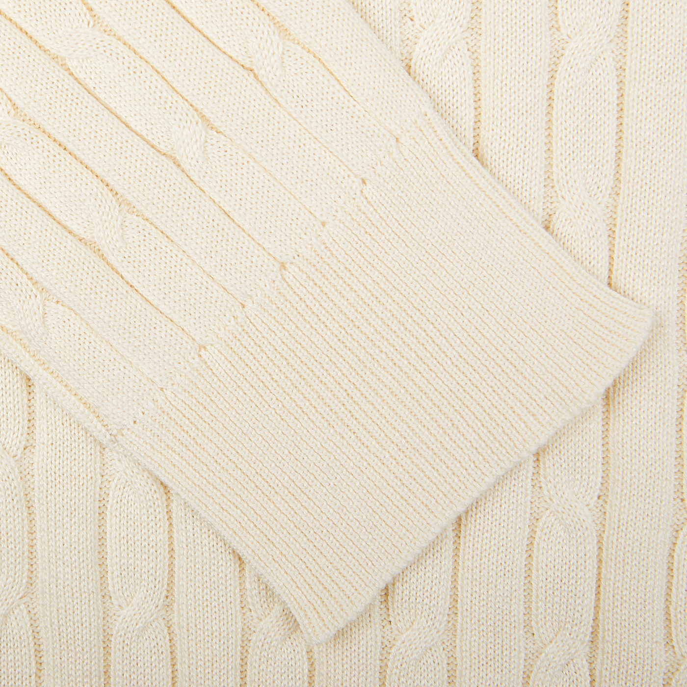 Close-up view of a Maurizio Baldassari cream-colored cotton-silk blend cable knit sweater fabric.