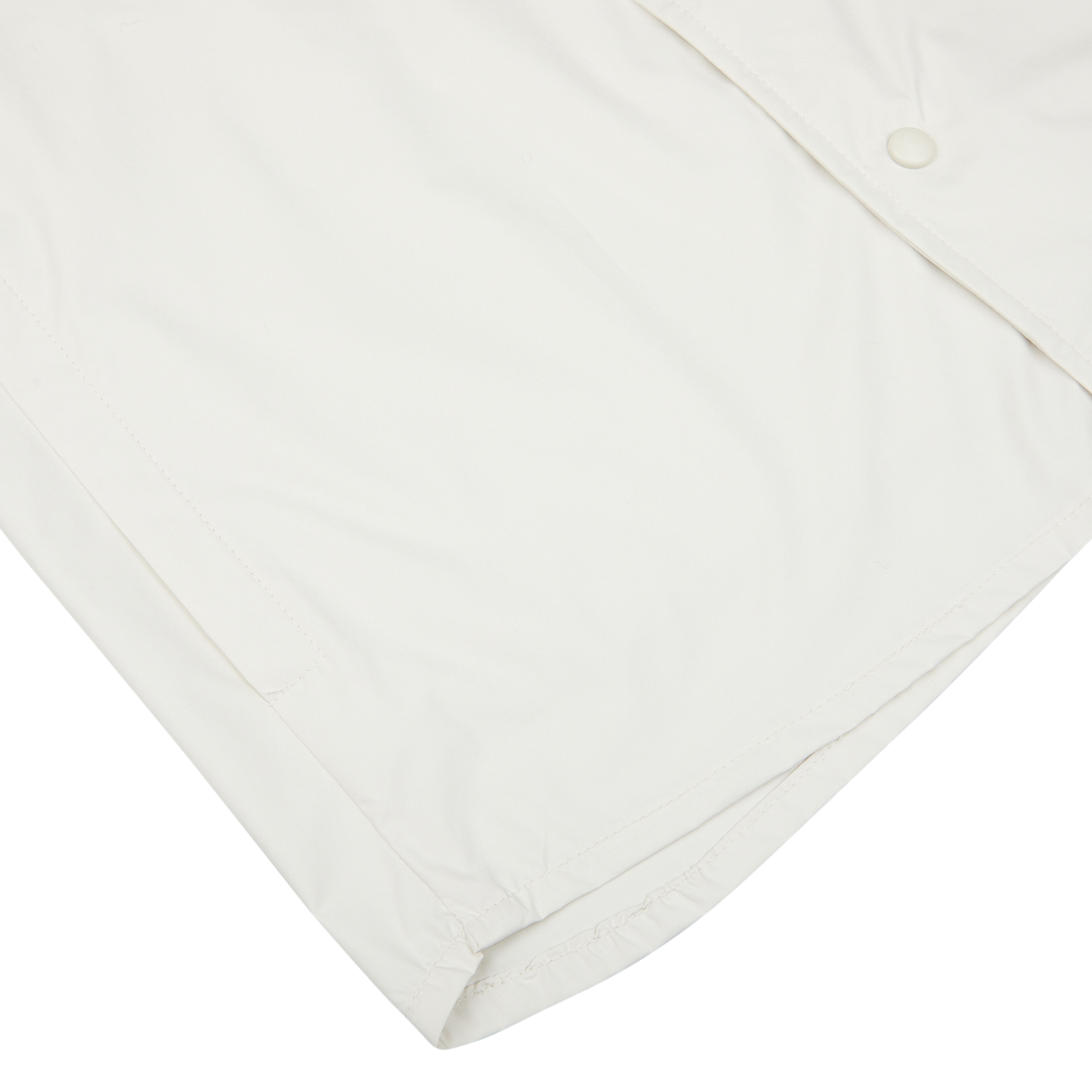 A close-up of a cream-colored, water-resistant nylon Mazzarelli technical overshirt with a snap button and visible stitching.