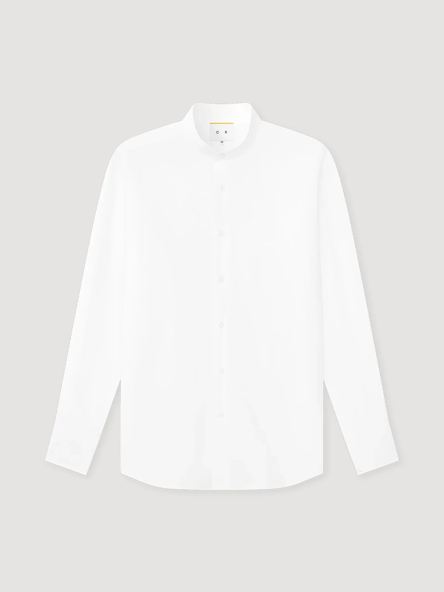 The White Poplin Mandarin Collar Shirt by Coconut Residence is crafted from 100% cotton poplin, featuring a clean, minimalist design with no visible pockets or patterns, and is shown against a light gray background. , available at Richard Gelding Mayfair