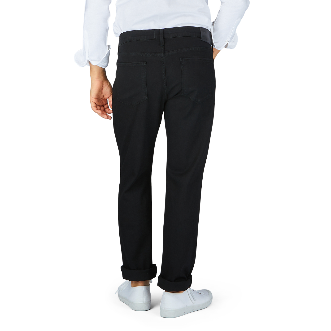 Person wearing black Paige Black Shadow Cotton Transcend Normandie Jeans in a regular fit and white shoes standing against a neutral background.