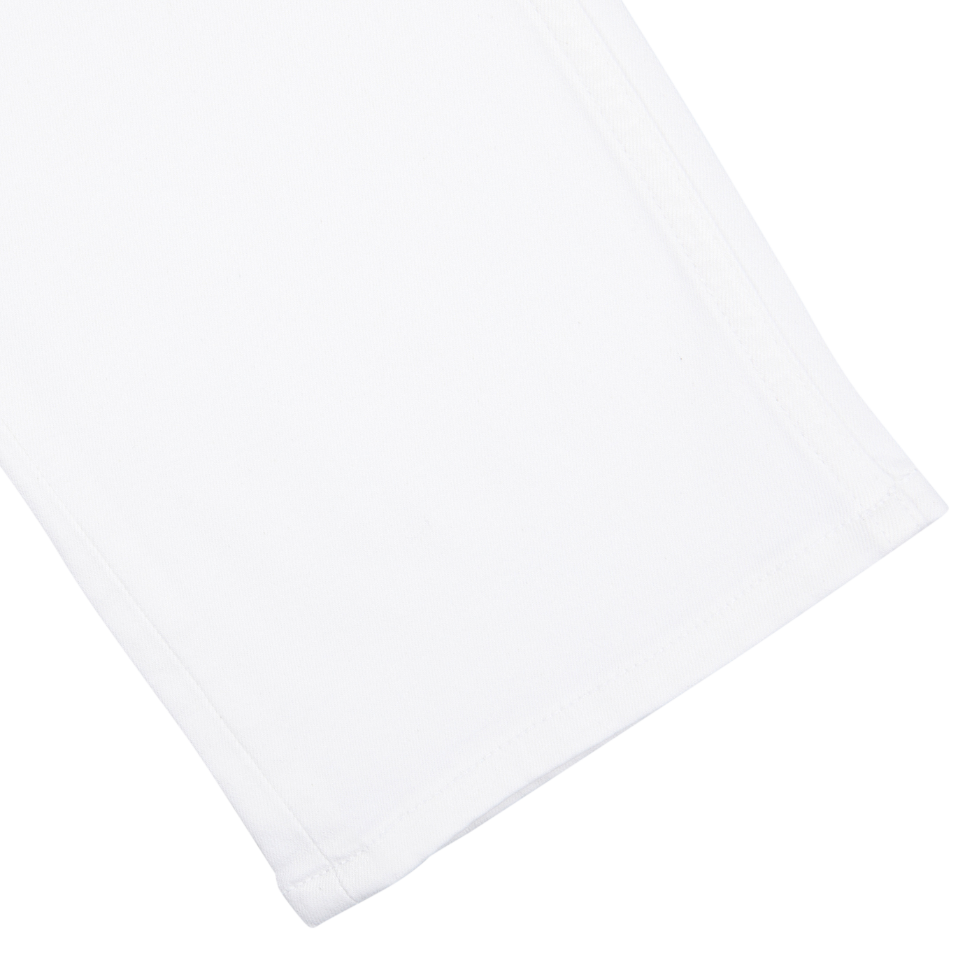 Close-up of a folded Icecap White Cotton Transcend Federal Slim Jeans by Paige on a white background.