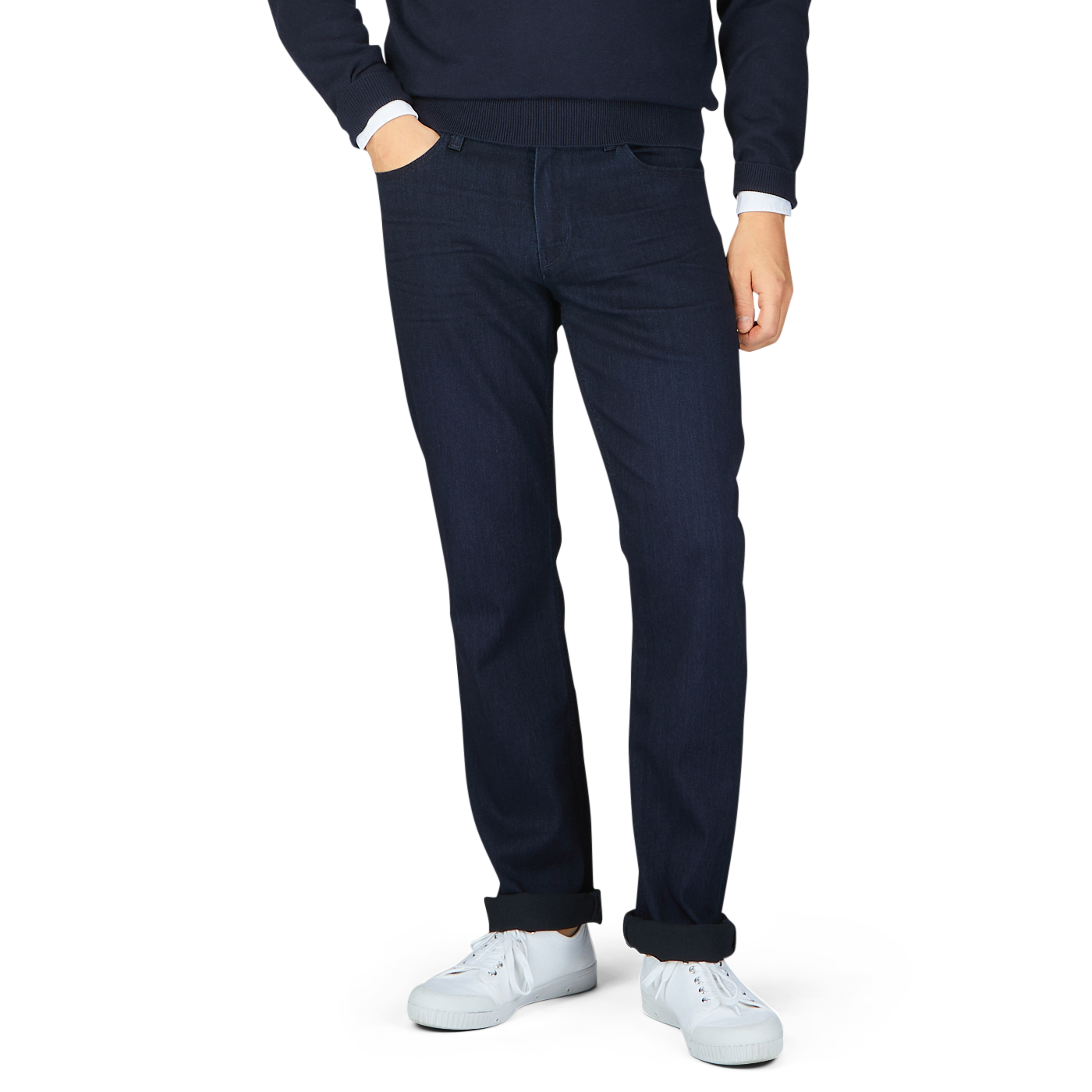Man standing in Paige's Inkwell Blue Cotton Transcend Normandie jeans and white sneakers.