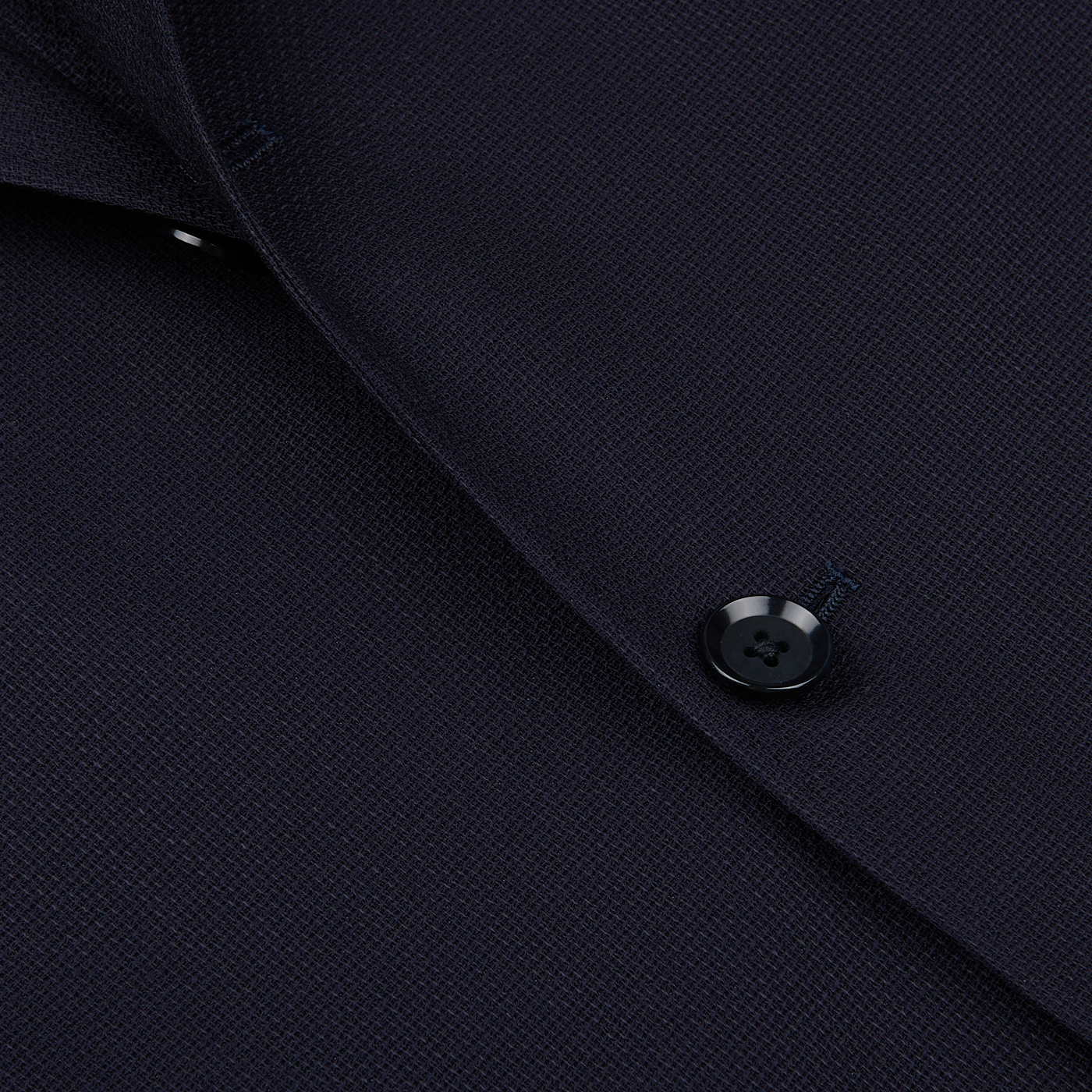 Close-up of a Ring Jacket Navy Blue Wool Balloon Travel Blazer featuring a detailed view of a button and fabric texture.