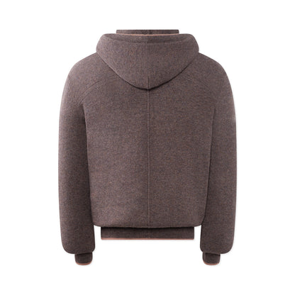 The TECHIN Light Brown Cashmere Hoodie is shown from the back, featuring long sleeves, ribbed hem and cuffs, a vertical central seam, and soft, thick material ideal for colder weather. , available at Richard Gelding Mayfair