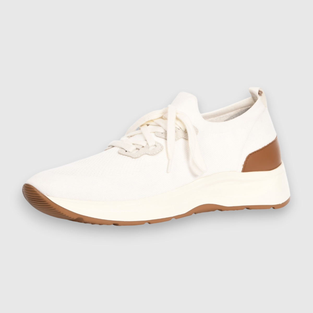 The Gran Sasso White Knitted Sneaker features a breathable knit, thick white sole, light brown tread, white laces, and a tan-brown heel accent—perfect for everyday comfort and style. Shown against a light gray background. , available at Richard Gelding Mayfair