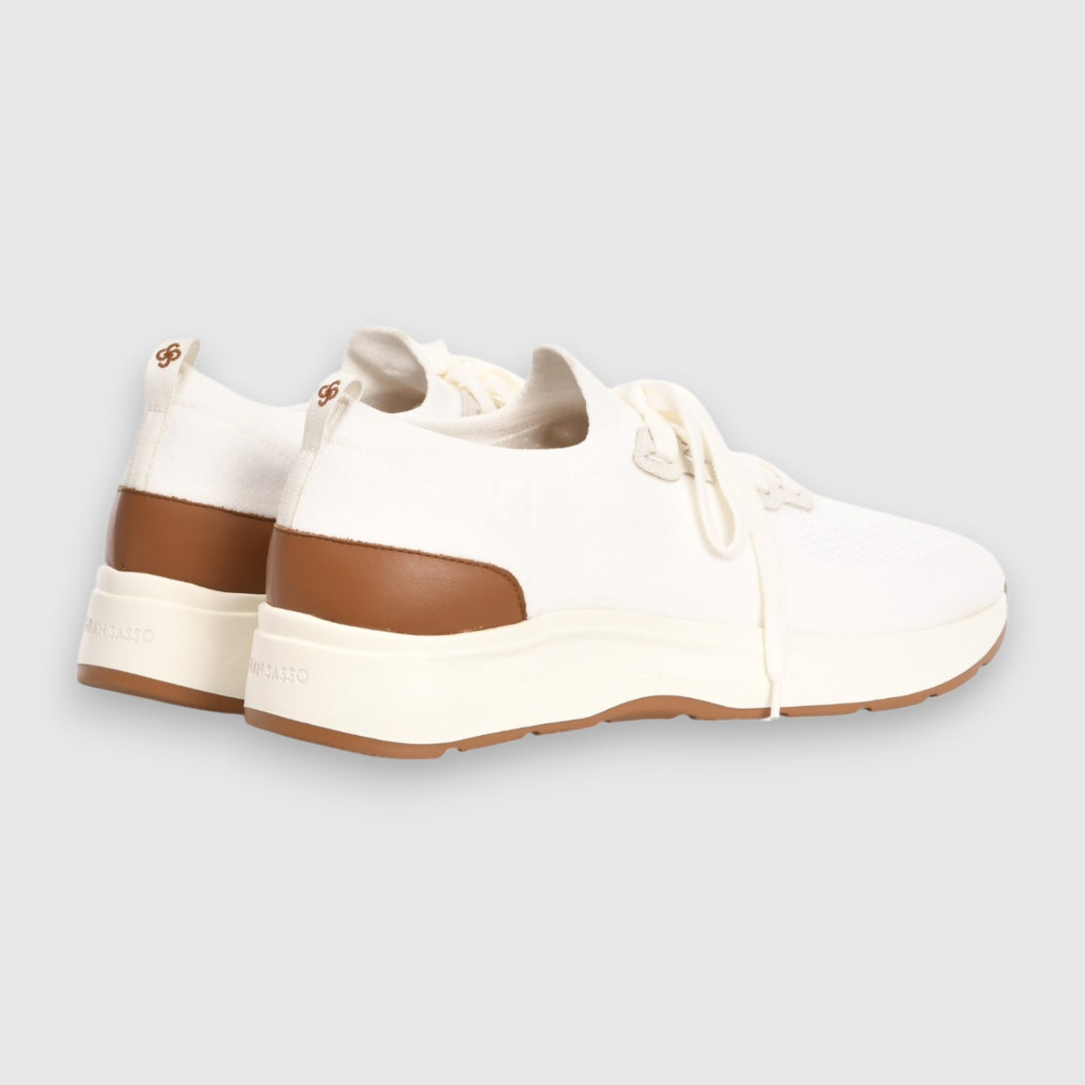 The Gran Sasso White Knitted Sneaker features an off-white knit upper, thick white soles, brown heel accents, white laces, and subtle branding on the heel and side. Shown from back and side angles on a light gray background. , available at Richard Gelding Mayfair