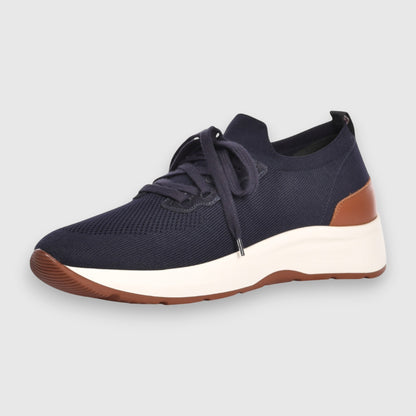 The Gran Sasso Navy Blue Knitted Sneakers feature a mesh upper, white thick sole, brown heel accent, brown outsole detail, and navy laces. Their modern sporty design is highlighted against a light gray background. , available at Richard Gelding Mayfair