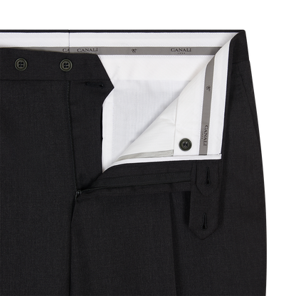 Close-up of the waistband and fly of Canali Black Flat Front Wool Trousers, partially unbuttoned and unzipped to show a white inner lining with gray trim, branded "Canali," and dark buttons. , available at Richard Gelding Mayfair