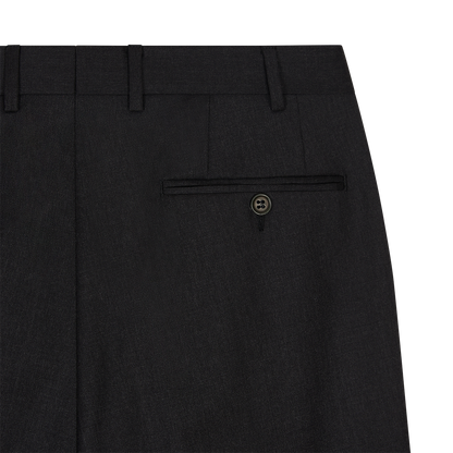 Close-up of Canali Black Flat Front Wool Trousers shows waistband with belt loops, single right back welt pocket with dark button, neatly stitched seams, and smooth, slightly textured wool fabric. , available at Richard Gelding Mayfair