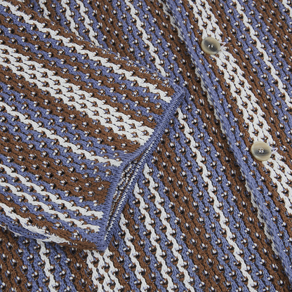 Close-up of Altea's Brown Blue Cream Cotton Knitted Polo, showcasing alternating diagonal stripes and textured openwork with a sleeve cuff and two metallic buttons—a stylish, versatile choice for any traveler’s wardrobe. , available at Richard Gelding Mayfair
