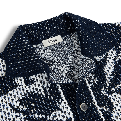 Close-up of Altea's Navy Cream Cotton Flower Open Weave shirt with a collar. A dark button on the placket and the label inside highlight its breathable cotton fabric and textured knit design. , available at Richard Gelding Mayfair