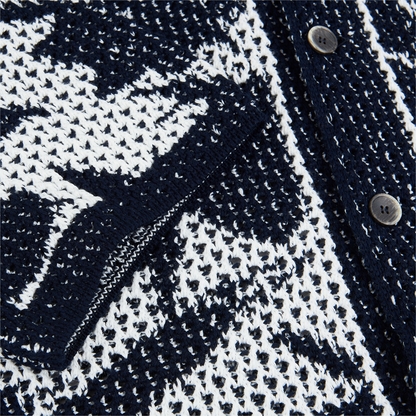 Close-up of the Altea Navy Cream Cotton Flower Open Weave cardigan, featuring a breathable mesh-like cotton knit, geometric pattern, front pocket, and black buttons. The partially open pocket reveals the airy textured design. , available at Richard Gelding Mayfair