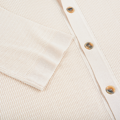 Close-up of the Altea Cream Blue Trim Waffle Cotton Button Polo, showing a sleeve and front with three glossy brown buttons. The cotton fabric features visible horizontal and vertical ribbing for a soft textured look. , available at Richard Gelding Mayfair