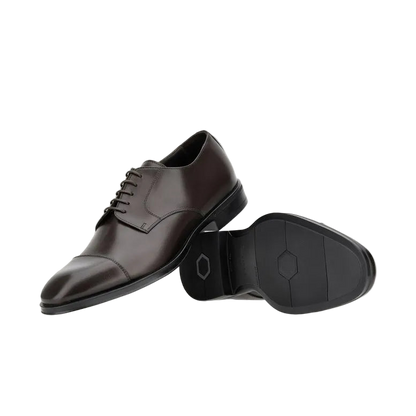 The image shows Canali Brown Calf Derby Shoes with Rubber Sole; one stands upright, displaying its rounded toe and laces, while the other lies on its side to highlight the black rubber sole’s geometric all-weather grip against a white background. , available at Richard Gelding Mayfair